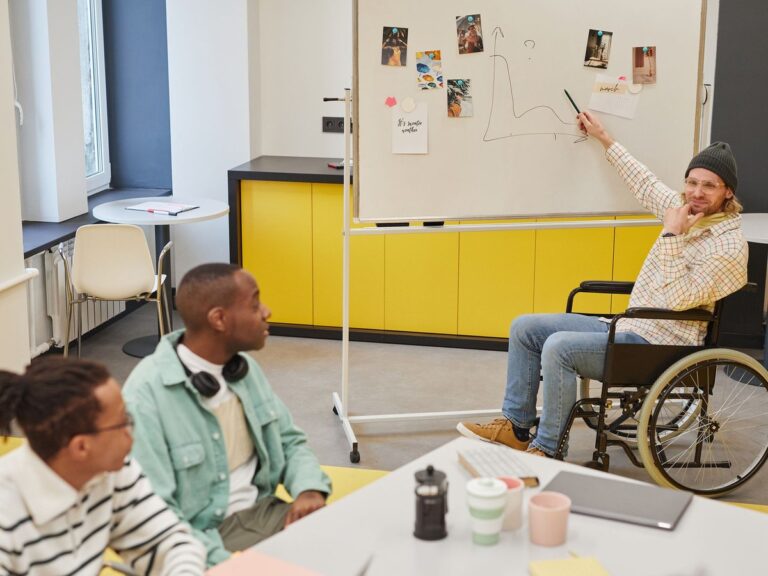 Team meeting in front of a mobile whiteboard with pinned notes