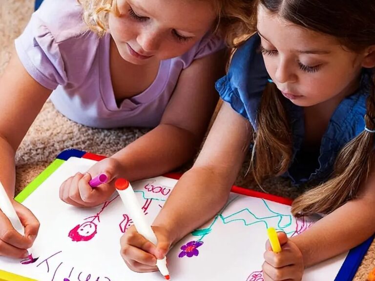 Two children drawing with colorful dry-erase markers
